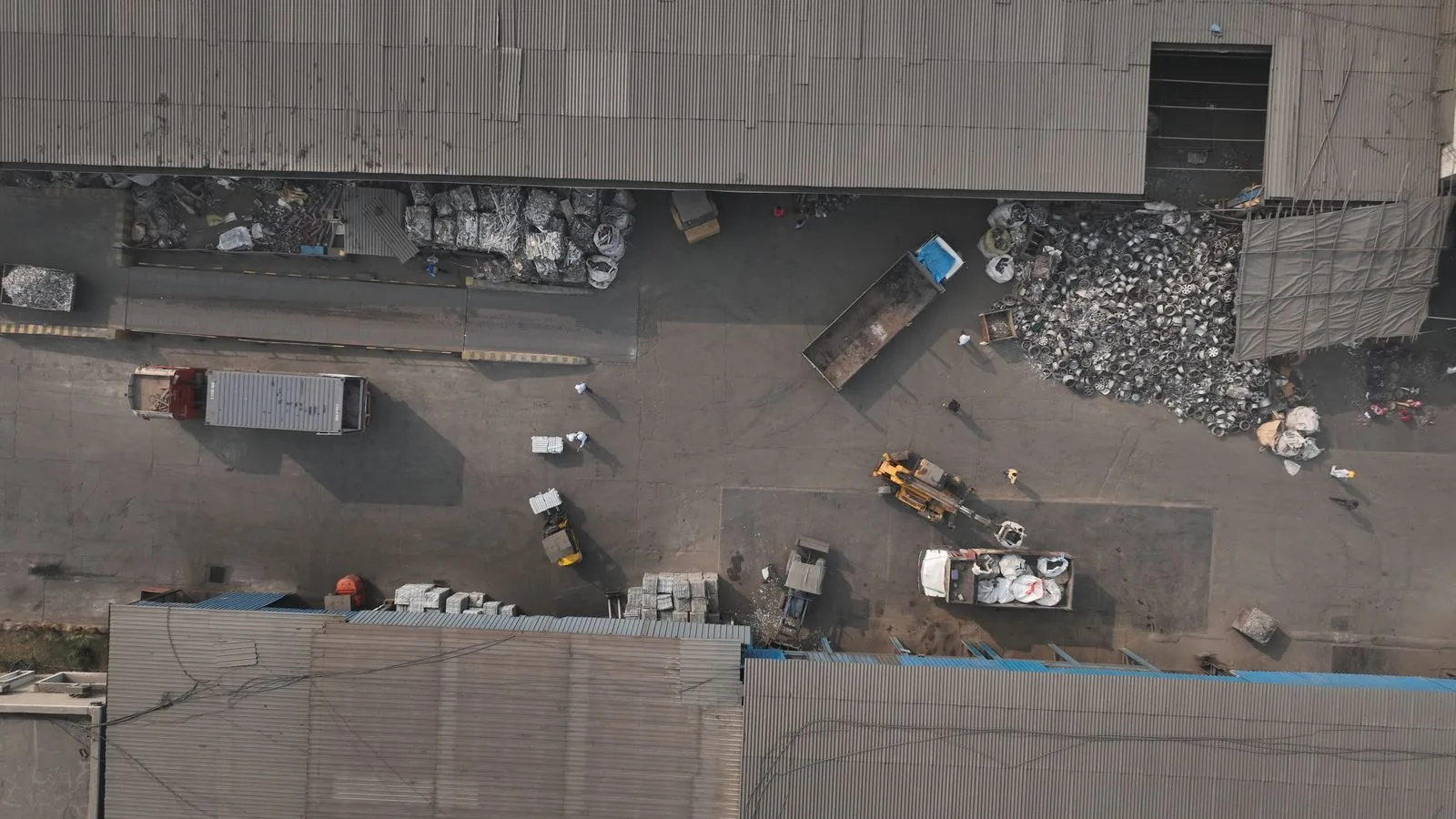 The receiving yard from above: trucks, bales and wheels waiting to be sorted
